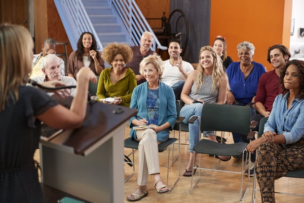 group-attending-neighborhood-meeting-listening-to-2024-10-19-11-54-27-utc