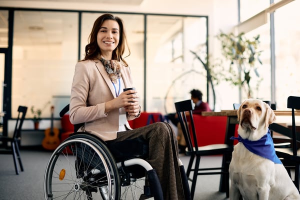happy-businesswoman-in-wheelchair-with-assistance-2022-12-06-01-17-46-utc