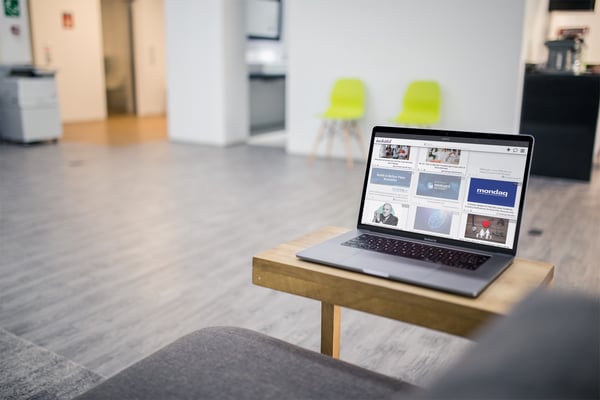 mockup-of-a-macbook-pro-resting-on-a-small-table-at-an-office-a20534