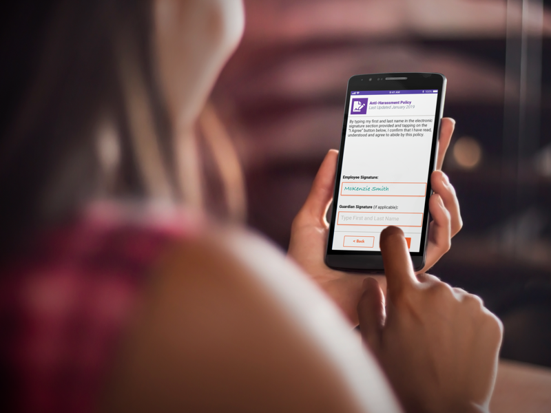 Woman digital signing an employee policy on her mobile phone.